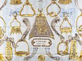 an image of a white and gold scarf with a picture of various items