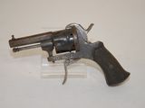 an old revolver with a wooden handle on a white surface