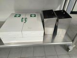 two boxes sitting on a metal table in the kitchen
