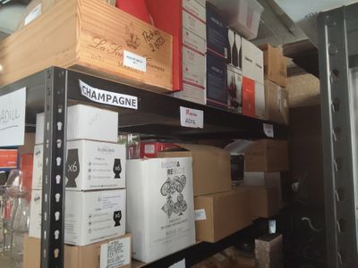many boxes of wine sitting on a shelf in a store