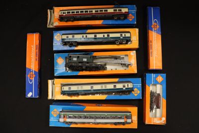 several boxed train cars are lined up on a black surface