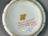 an image of a plate with writing on it with a maple leaf on it