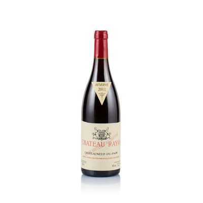 a bottle of red wine sitting on top of a white table