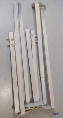 four pieces of white plastic are stacked on top of each other
