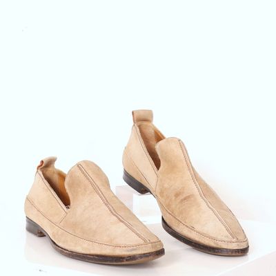 men ' s tan sued slip - on shoes on a white surface