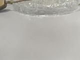 a glass bowl with a candle on a white table