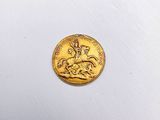 a close up of a gold coin with a horse and rider on it