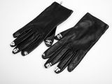 a pair of black leather gloves with skulls on them