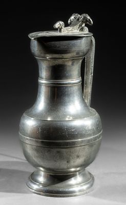 a silver vase that is sitting on a table