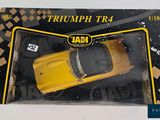 a yellow toy car in a box on a table