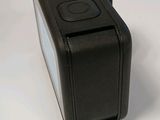 a black camera that is sitting on a white surface