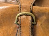 a brown bag that has a handle on it