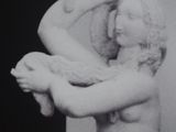 black and white photograph of a statue of a woman holding a baby