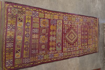 a rug hanging on a wall in a room