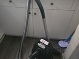 a vacuum that is sitting on the floor next to a window