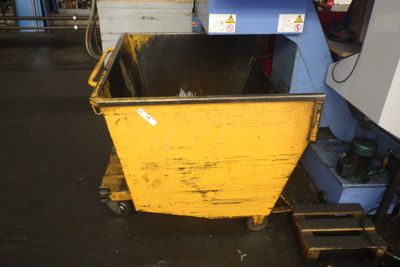une benne jaune qui se trouve dans un garage