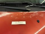 a sticker on the hood of a red car