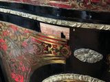 a black and red cabinet with gold decorations on it