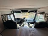 a bed in the back of a truck with a view of the inside of it