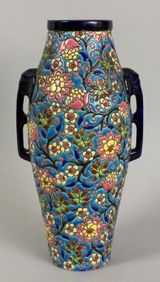 a blue vase with a floral design on it