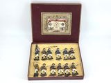 figurines of men dressed in uniforms in a wooden box