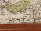 a picture of a map of asia in a wooden frame