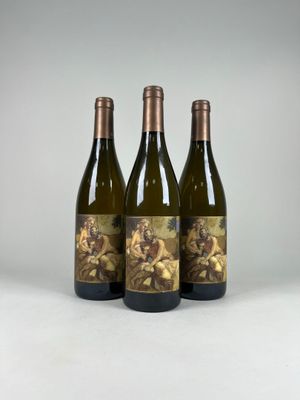 three bottles of wine sitting next to each other on a table