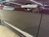 a close up of a car door handle with a sticker on it