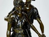 bronze statue of a boy and a girl holding hands