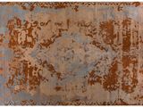 a brown and blue rug with a rusted design on it