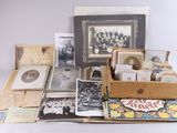an assortment of old photographs and photographs in a wooden box on a white surface