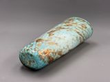 a blue and brown vase sitting on a gray surface