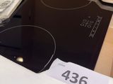 a black stove top in a box with a price tag on it