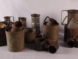 a lot of old tins that are sitting on a table