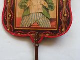 tableau représentant une femme en train de lire un journal sur un éventail rouge et noir
