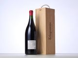 a bottle of red wine next to a wooden box