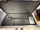 a suitcase with a caliper in it sitting on a table