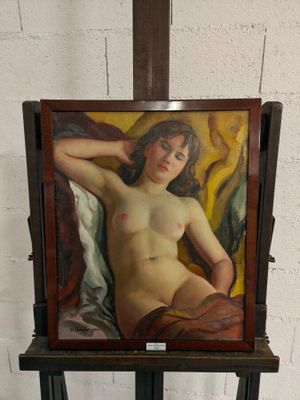 un tableau représentant une femme nue sur un chevalet