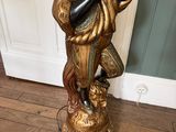 a statue of a woman holding a cat in her arms