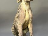 statue of a dog sitting on top of a stone block