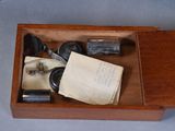 a wooden box with a pair of glasses and a note in it