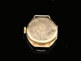 an image of a gold watch on a black surface