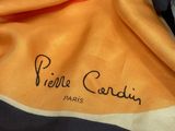 a yellow and black scarf with a name on it