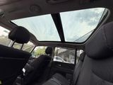 a view of the sunroof from inside of a car