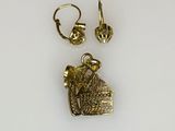 two pairs of gold earrings and a pendant with a bird on it