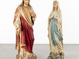 two statues of jesus and mary are standing next to each other