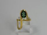 a close up of a gold ring with a green stone