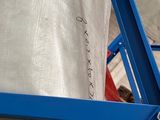 a close up of a blue metal frame with a bag on it