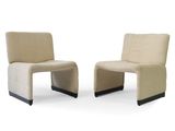 pair of beige chairs with black legs on a white background
