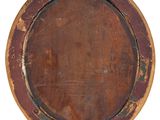 a round wooden plate with a rusted surface on a white background